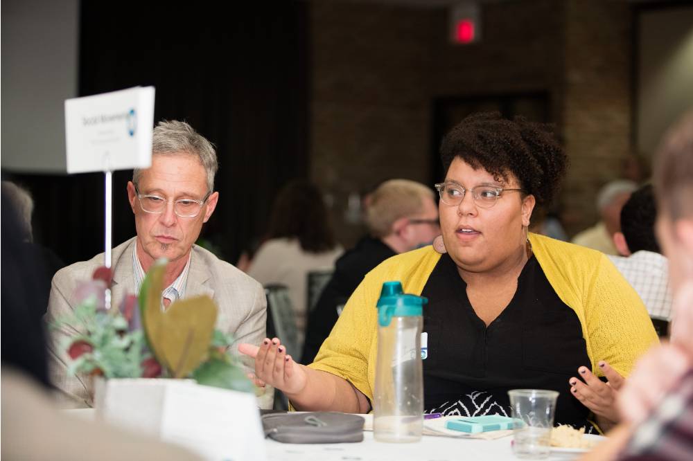 Image 1 of 30 A women shares her views during the round table discussions.